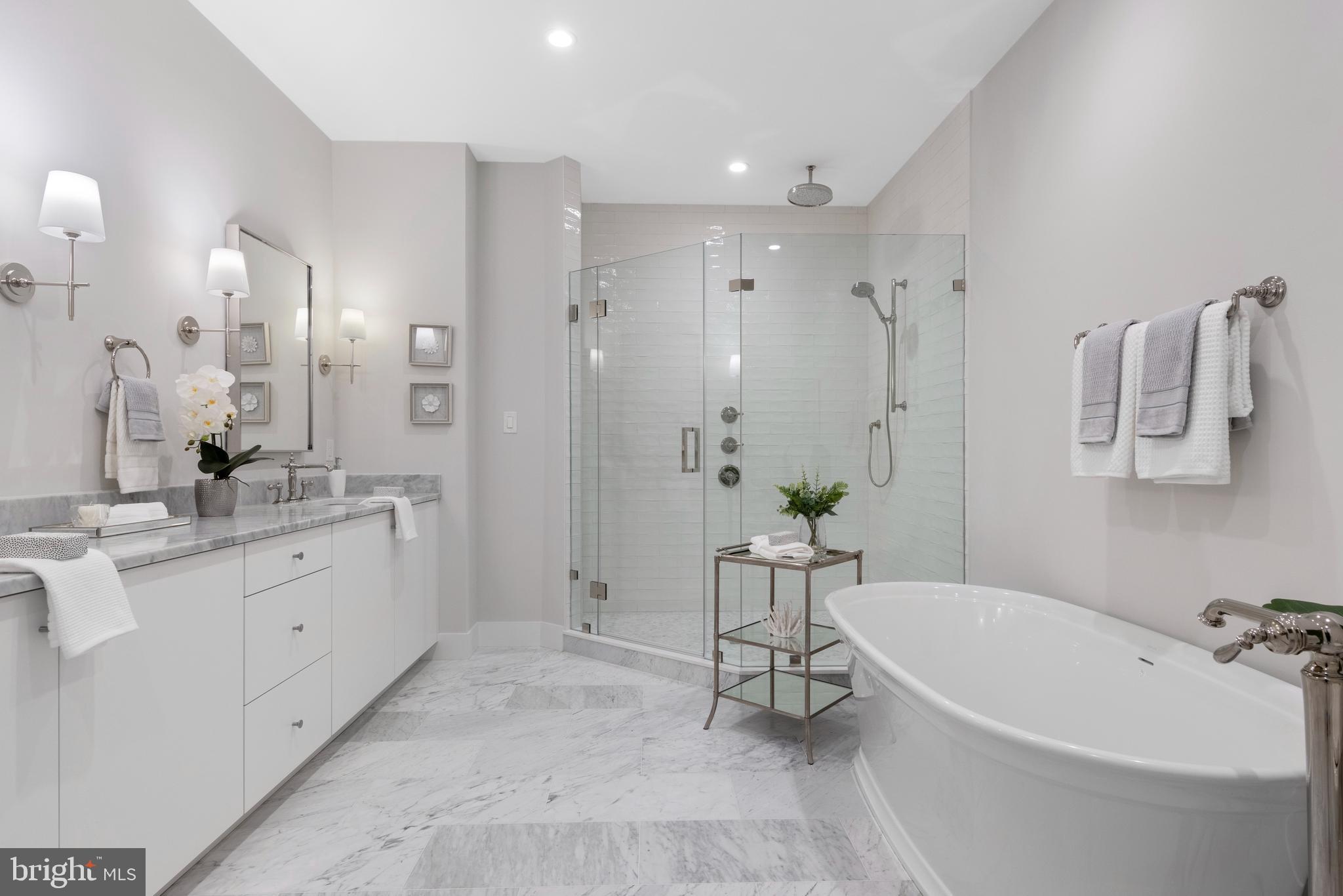 427 East Lancaster Avenue, Unit 2201 Wayne, PA 19087 - Photo 31 of 46 a spacious bathroom with a granite countertop tub sink and mirror