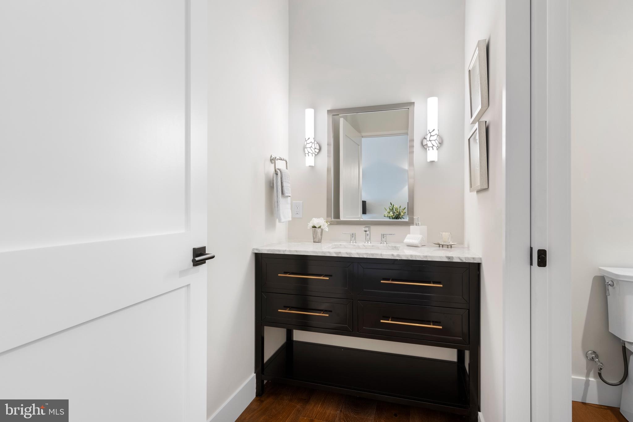 427 East Lancaster Avenue, Unit 2201 Wayne, PA 19087 - Photo 6 of 46 a bathroom with a sink a toilet and a mirror