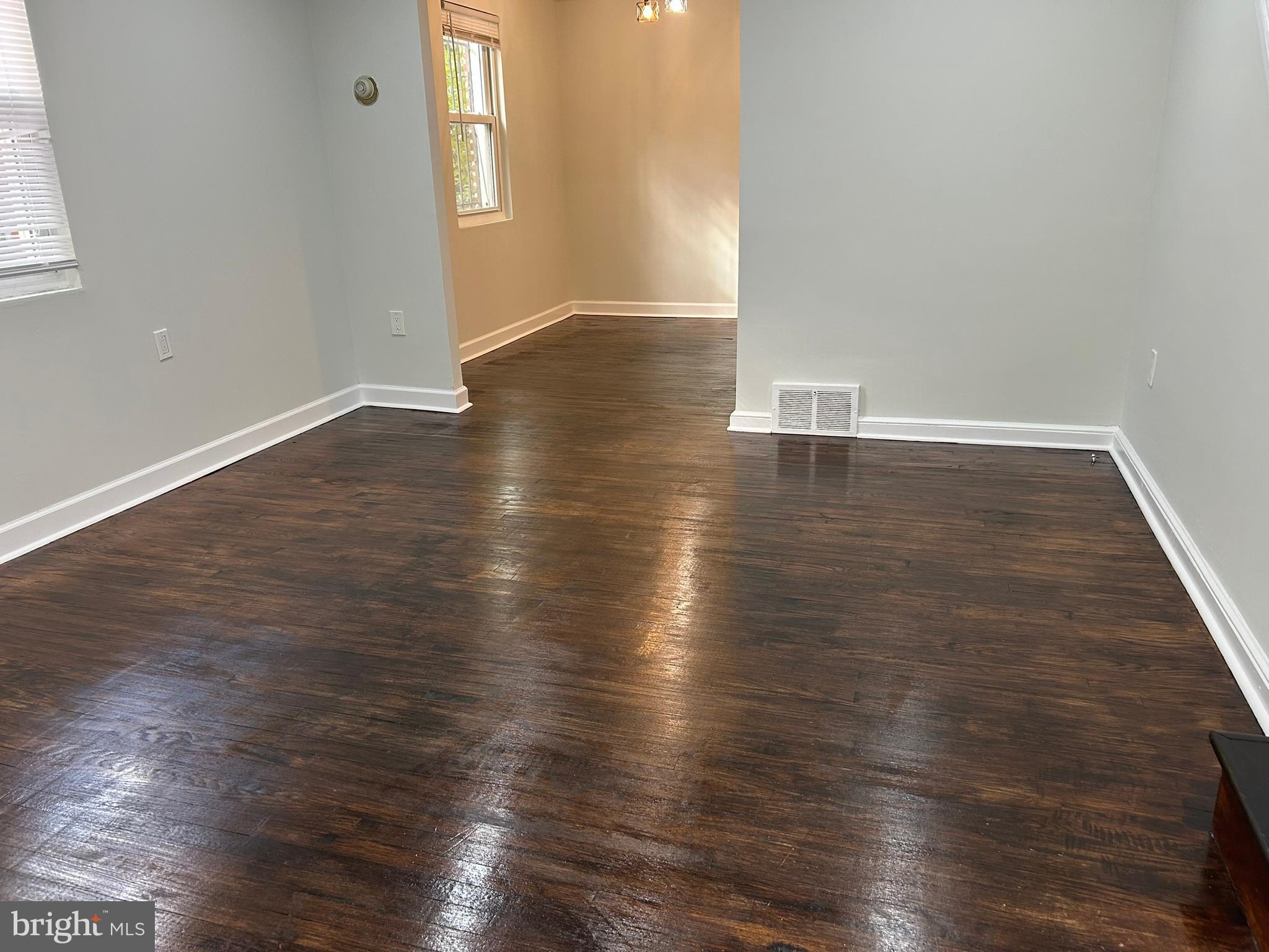 6643 Church Lane Upper Darby, PA 19082 - Photo 2 of 11 an empty room with wooden floor and windows
