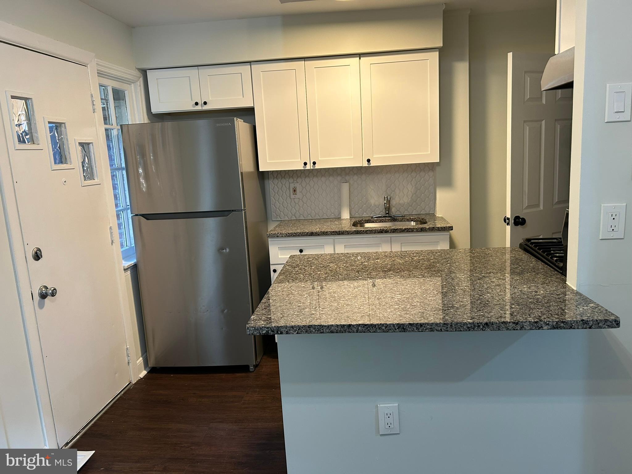 6643 Church Lane Upper Darby, PA 19082 - Photo 4 of 11 a kitchen with kitchen island a counter top space and a refrigerator
