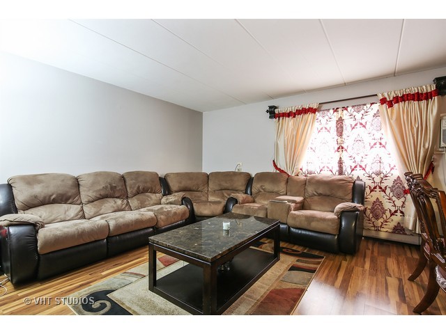 214 East Bailey Road, Unit A Naperville, IL 60565 - Photo 2 of 10 a living room with furniture and a large window
