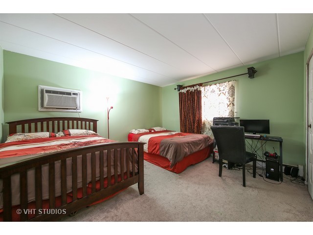 214 East Bailey Road, Unit A Naperville, IL 60565 - Photo 7 of 10 a bedroom with a bed table chair and a window