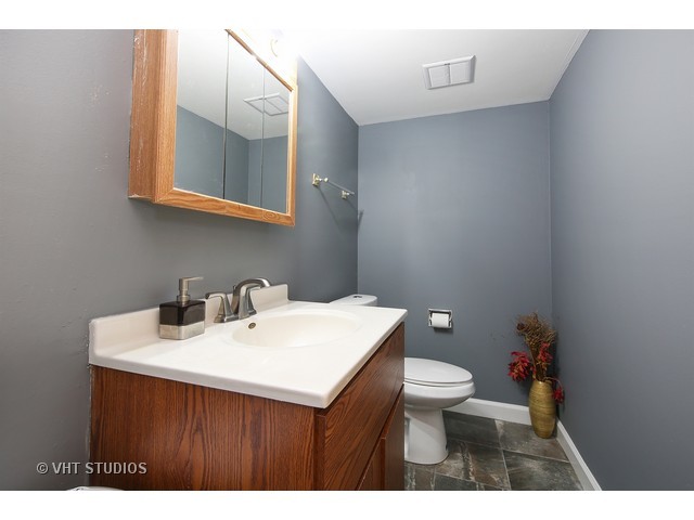 214 East Bailey Road, Unit A Naperville, IL 60565 - Photo 8 of 10 a bathroom with a sink a toilet and mirror