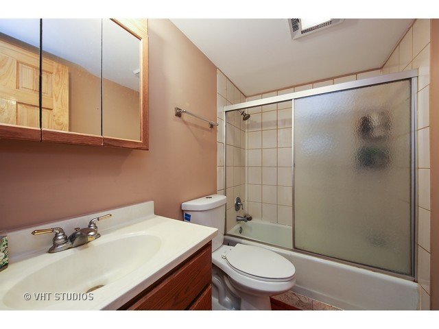 214 East Bailey Road, Unit A Naperville, IL 60565 - Photo 9 of 10 a bathroom with a sink a toilet and shower