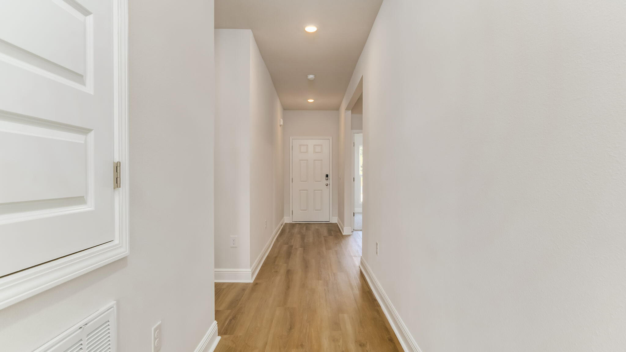 5619 Thatcher Road Crestview, FL 32539 - Photo 22 of 32 a view of a hallway with wooden floor