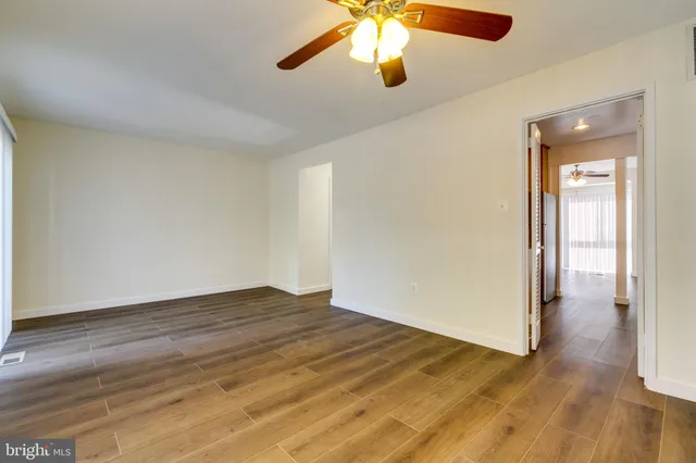 wooden floor in an empty room with a window