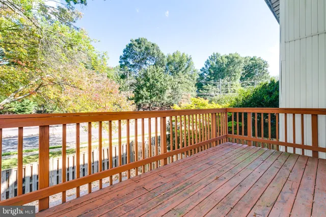 a balcony with wooden floor and fence