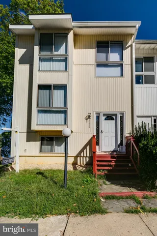 a view of a house with a small yard and plants