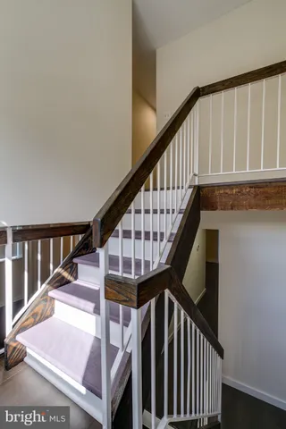 an empty room with closet and a chandelier fan