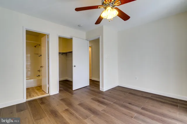 a bathroom with a granite countertop sink toilet and a mirror