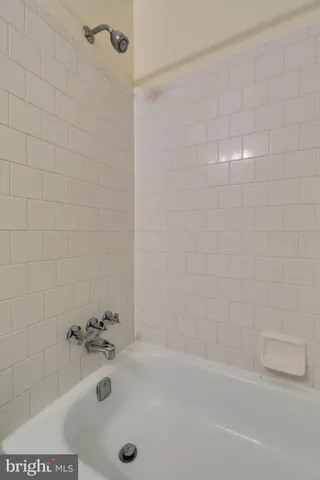 a view of an empty room with wooden floor and closet