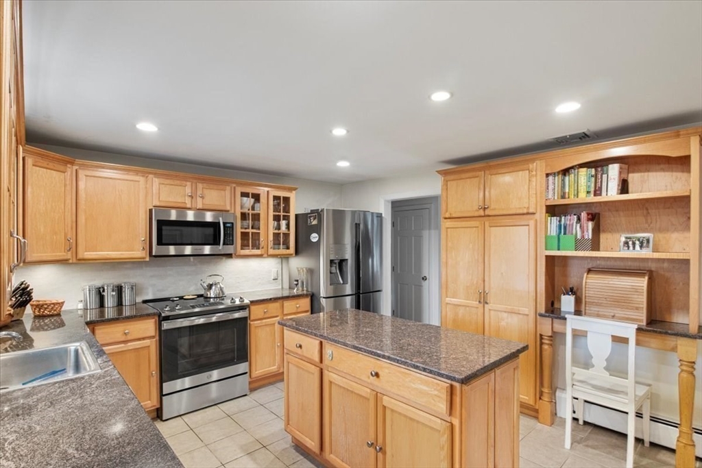 23 Glover Road Needham, MA 02494 - Photo 15 of 40 a kitchen with stainless steel appliances granite countertop a stove a sink and a refrigerator