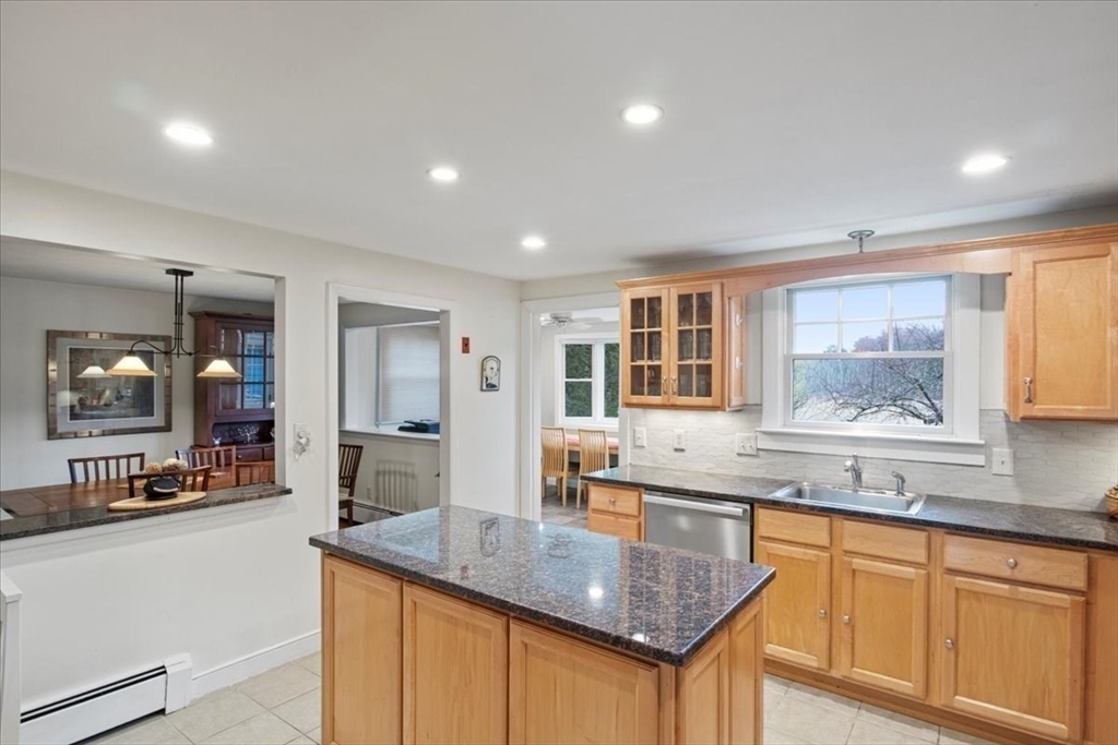 23 Glover Road Needham, MA 02494 - Photo 16 of 40 a kitchen with granite countertop kitchen island a sink and a large window