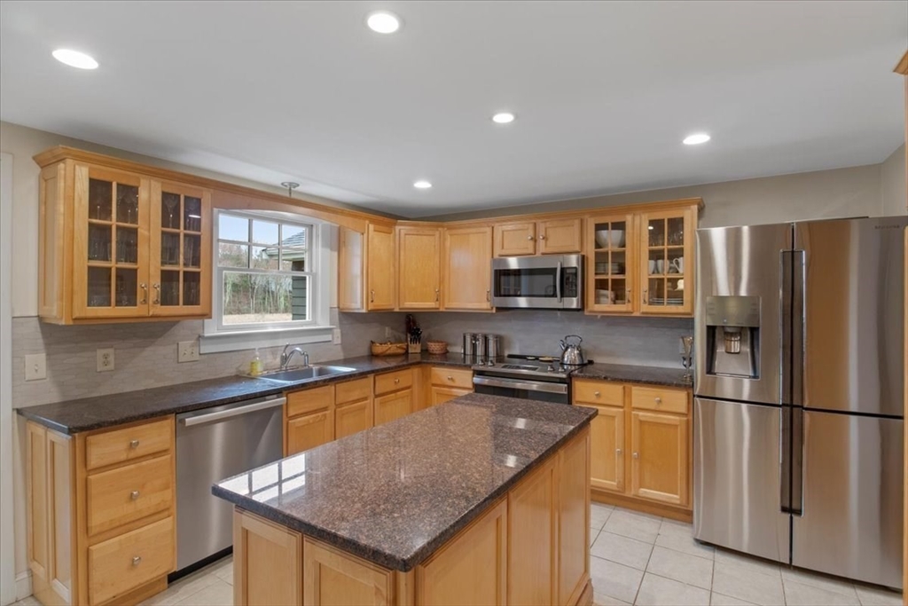 23 Glover Road Needham, MA 02494 - Photo 17 of 40 a kitchen with stainless steel appliances granite countertop a sink stove and refrigerator