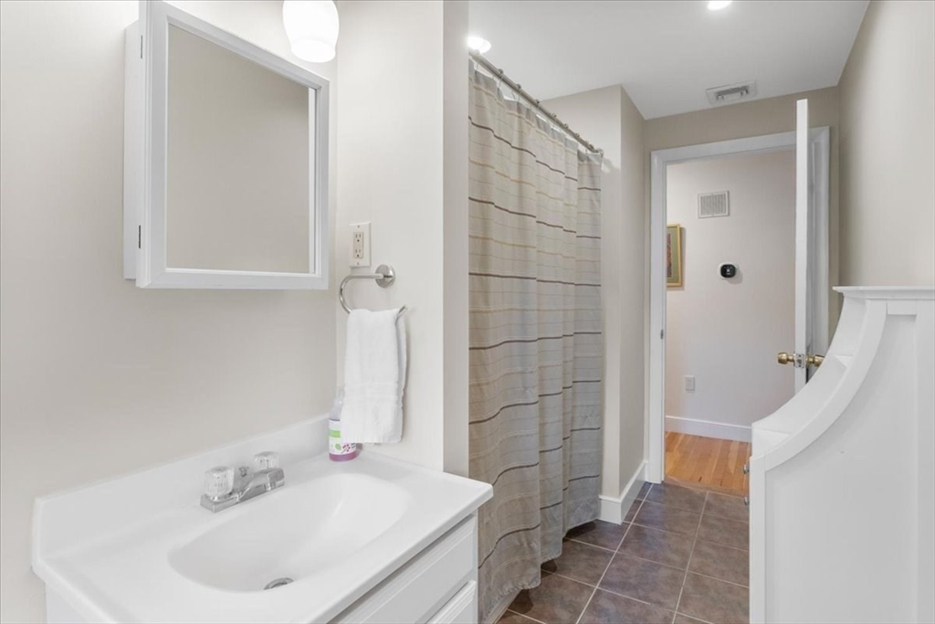 23 Glover Road Needham, MA 02494 - Photo 19 of 40 a bathroom with a sink a toilet and shower