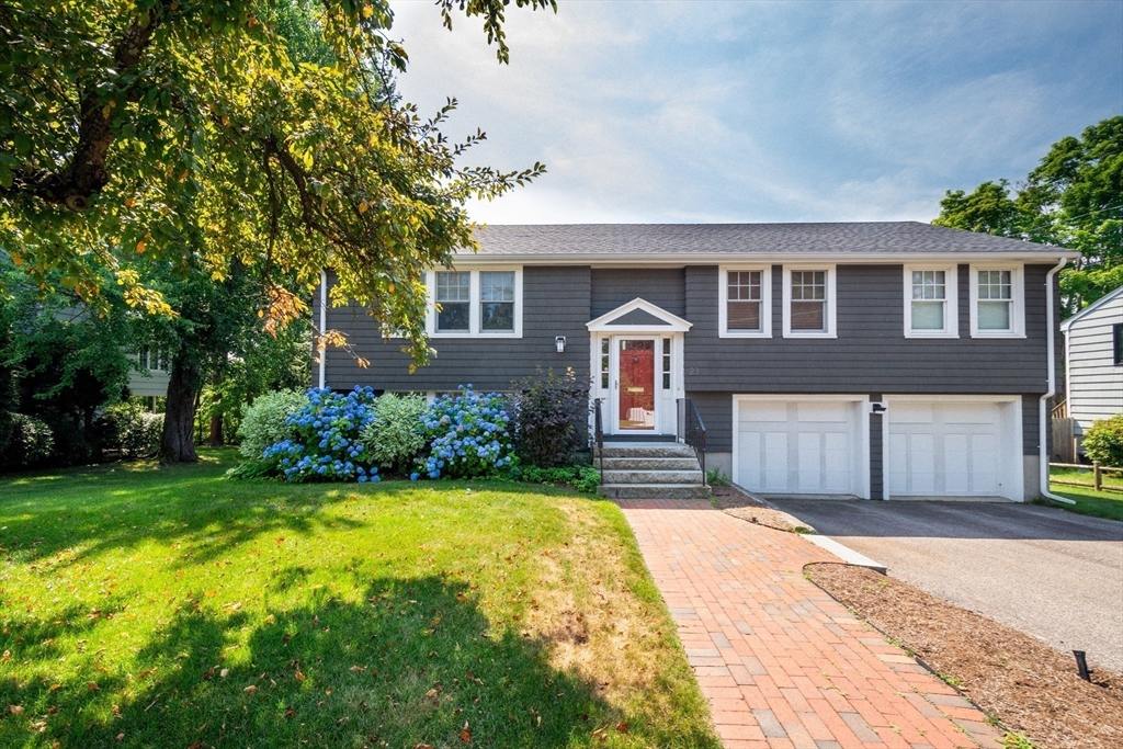 23 Glover Road Needham, MA 02494 - Photo 2 of 40 a front view of a house with a garden and yard