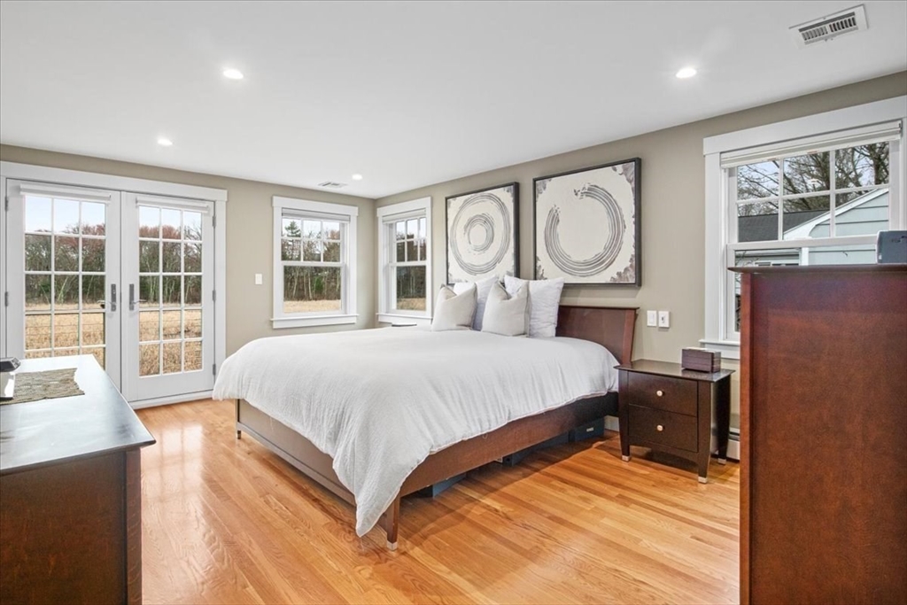23 Glover Road Needham, MA 02494 - Photo 22 of 40 a bedroom with a large bed and a large window