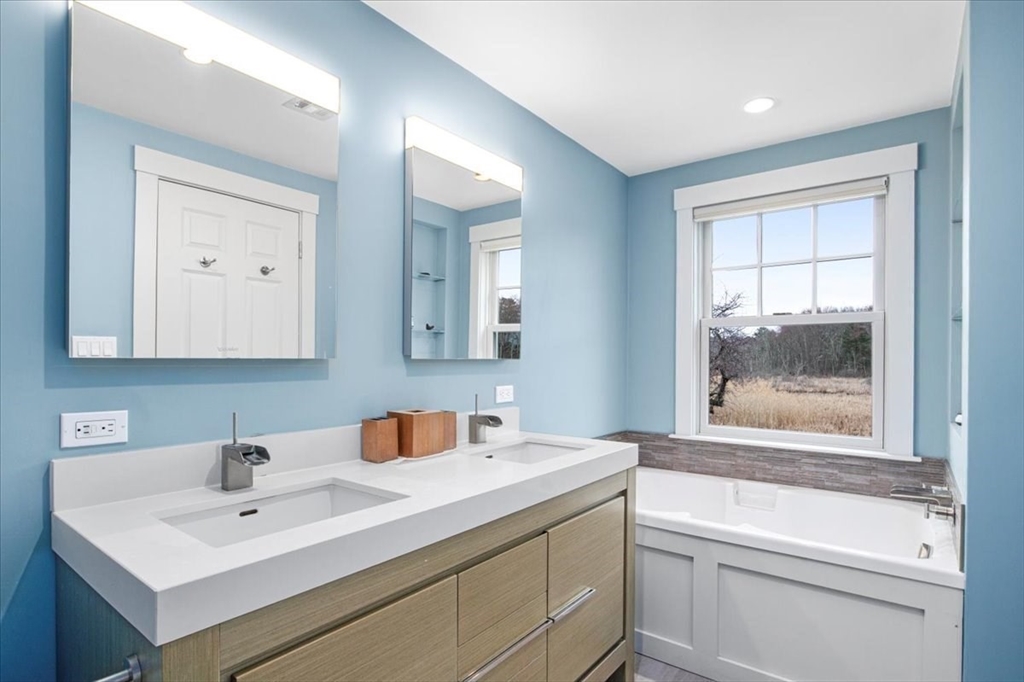 23 Glover Road Needham, MA 02494 - Photo 25 of 40 a bathroom with a sink and a mirror