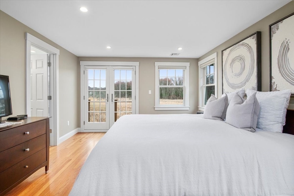 23 Glover Road Needham, MA 02494 - Photo 33 of 40 a large bedroom with a large bed and a window
