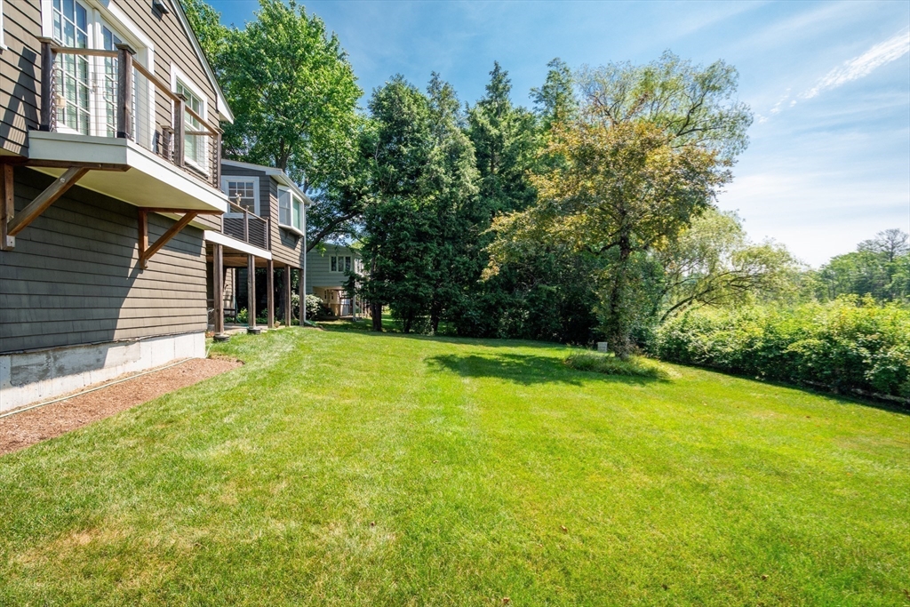 23 Glover Road Needham, MA 02494 - Photo 8 of 40 a view of a patio with table and chairs and potted plants