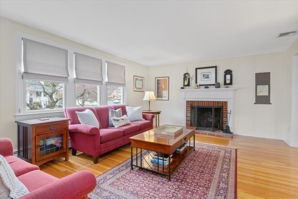 23 Glover Road Needham, MA 02494 - Photo 10 of 40 a living room with furniture a rug and a fireplace