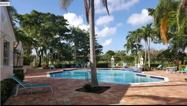 a sign board with yard and trees
