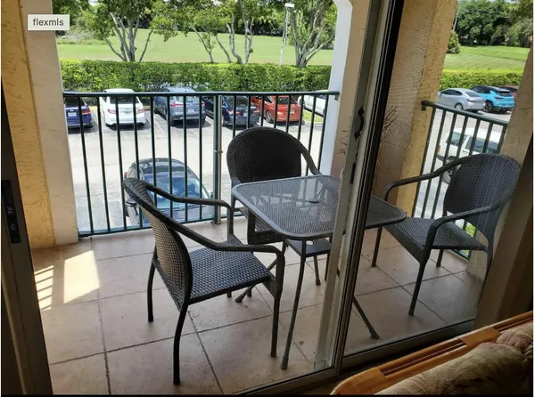 a view of balcony with wooden floor and outdoor seating