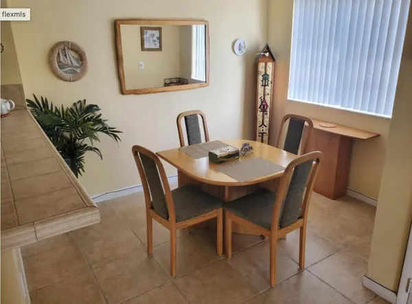 a view of a dining room with furniture and a potted plant