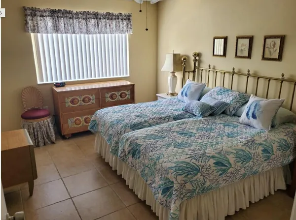 a bedroom with a bed and dresser