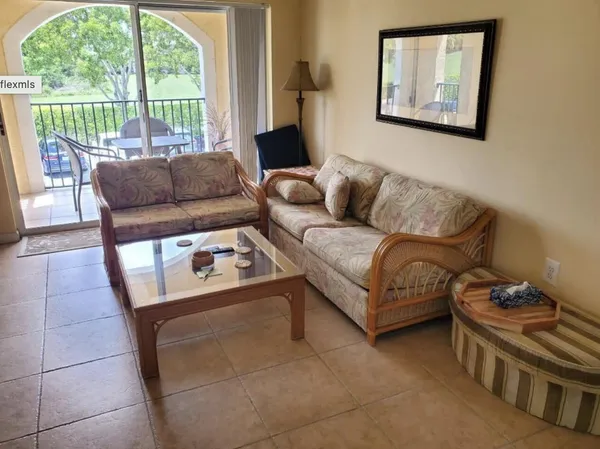 a living room with furniture and a large window