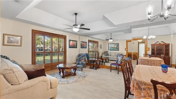 a living room with furniture and a chandelier