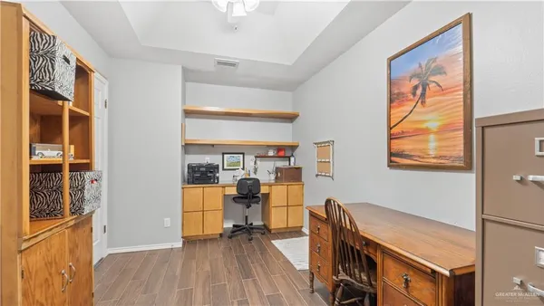 a view of a workspace with furniture and a window