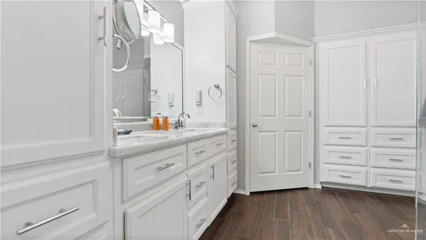 a bathroom with a double vanity sink and mirror