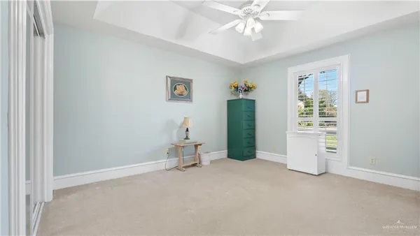 an empty room with closet and windows
