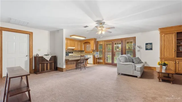 a living room with furniture and large windows
