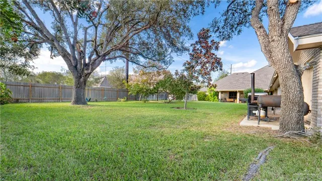 a view of house with backyard and a slide
