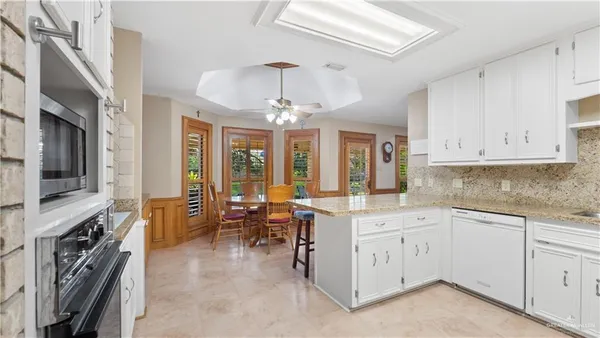 a open kitchen with stainless steel appliances granite countertop a stove and cabinets
