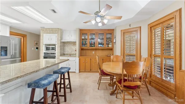 a dining room with furniture a window and wooden floor