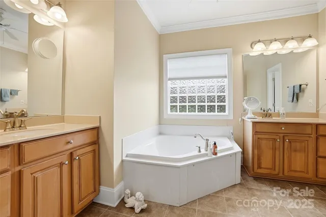 a spacious bathroom with a tub sink and mirror