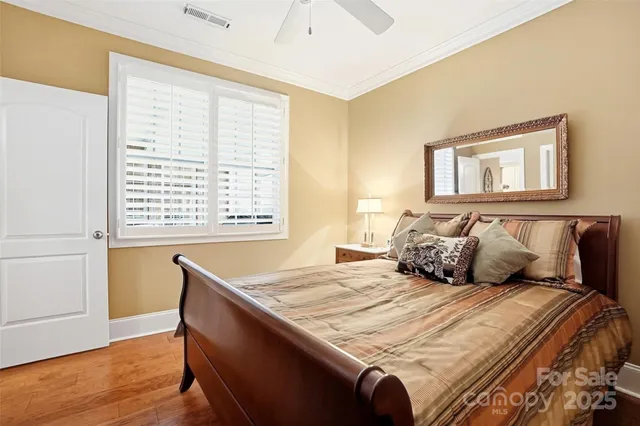 a bed sitting in a bedroom next to a window