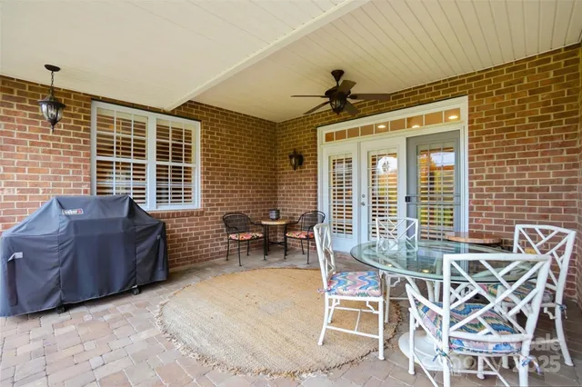 a view of a patio with a table and chairs