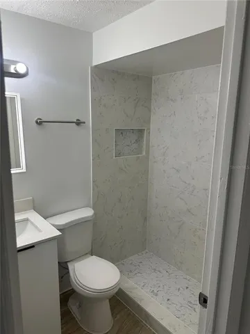 a white toilet sitting next to a bathroom sink