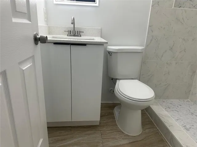 a white toilet sitting next to a bathroom sink