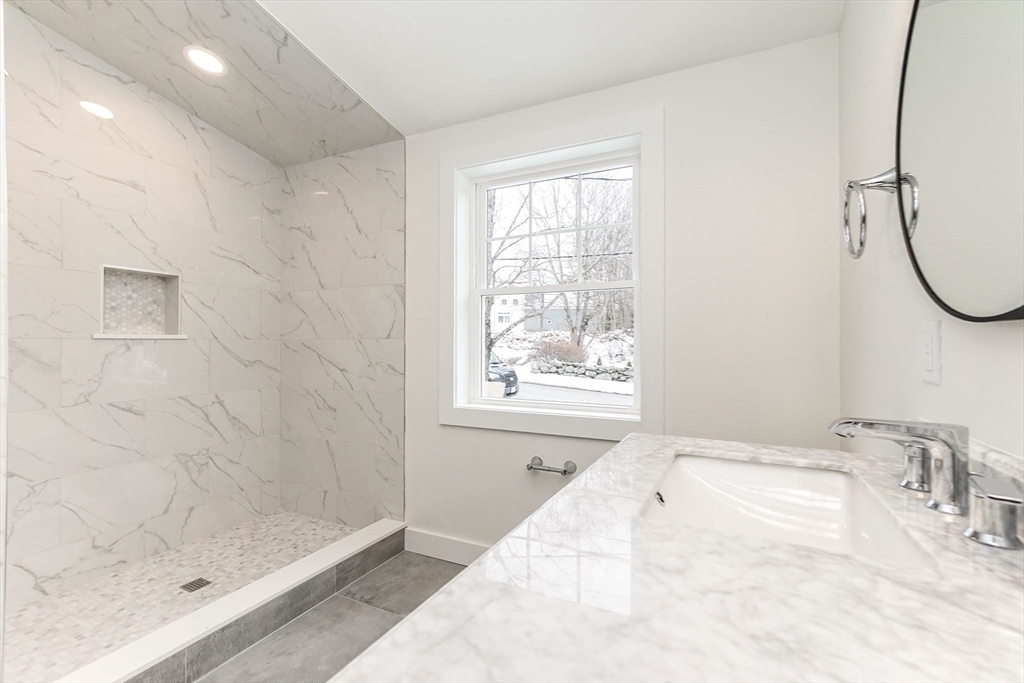 40 Great Road Maynard, MA 01754 - Photo 16 of 30 a bathroom with a sink a window and a shower