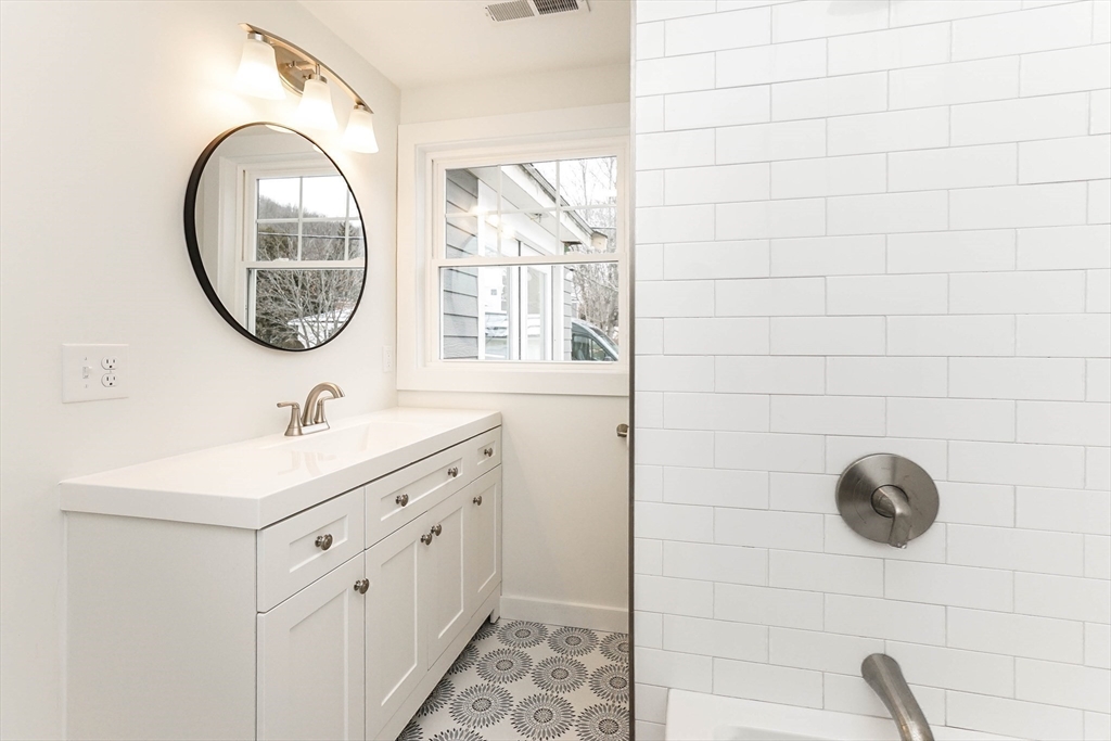40 Great Road Maynard, MA 01754 - Photo 19 of 30 a bathroom with a sink a mirror and a window
