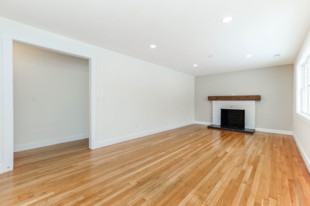 40 Great Road Maynard, MA 01754 - Photo 3 of 30 a view of empty room with wooden floor and fireplace