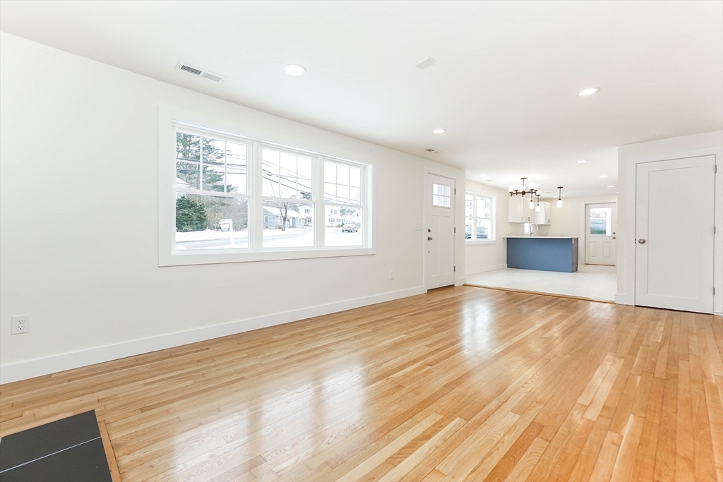 40 Great Road Maynard, MA 01754 - Photo 4 of 30 an empty room with wooden floor and windows