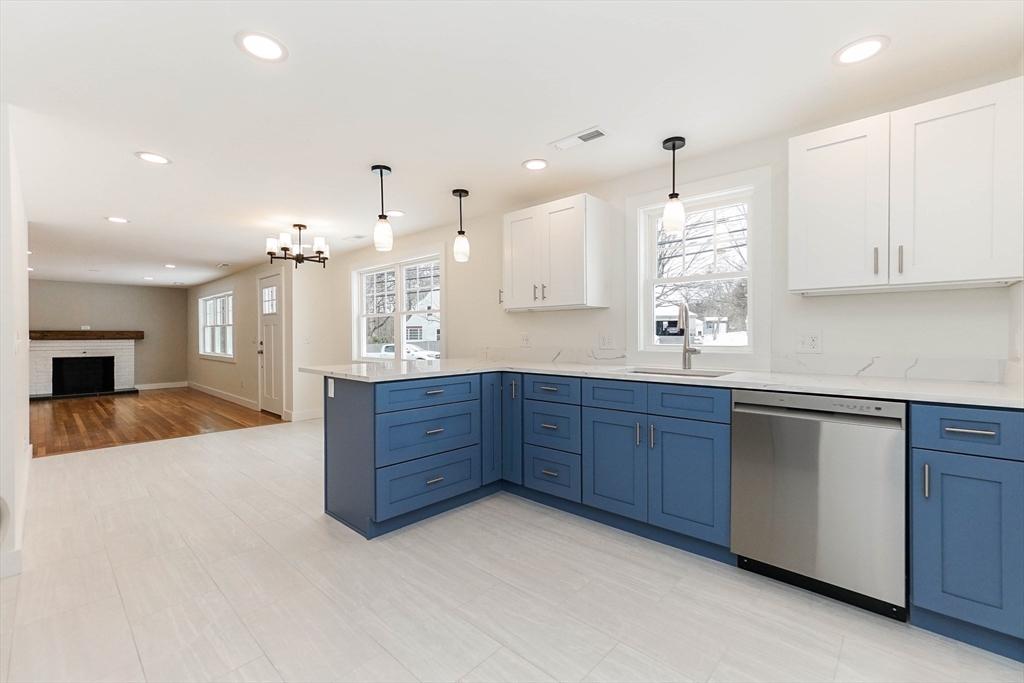 40 Great Road Maynard, MA 01754 - Photo 6 of 30 a large kitchen with stainless steel appliances kitchen island granite countertop a sink a stove and a cabinets