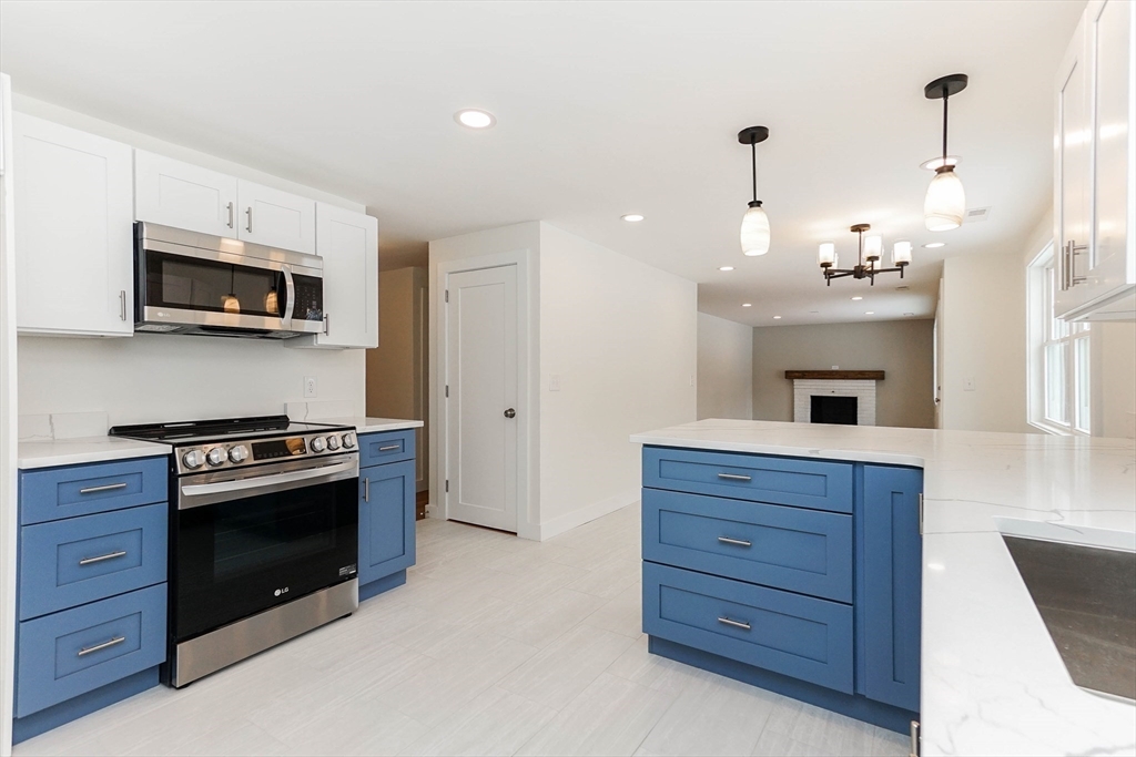40 Great Road Maynard, MA 01754 - Photo 7 of 30 a kitchen with a stove and a microwave oven