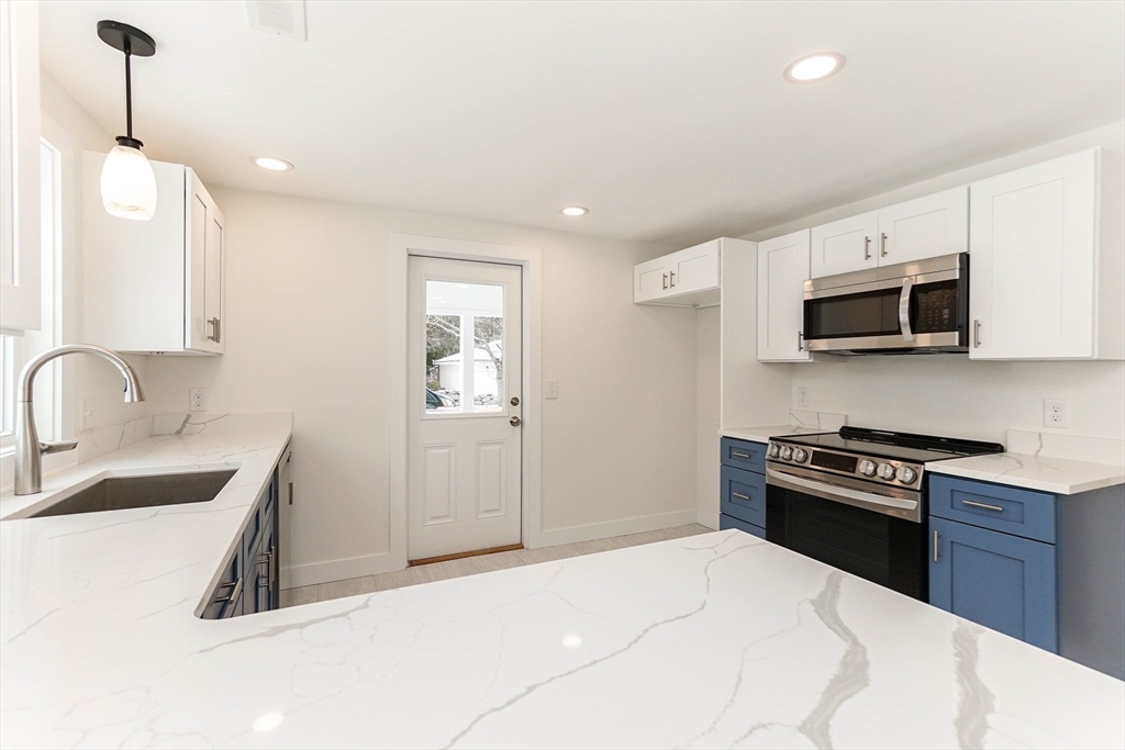 40 Great Road Maynard, MA 01754 - Photo 9 of 30 a kitchen with a sink a stove and microwave